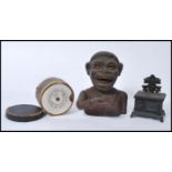 A group of vintage 20th century cast iron money banks / boxes to include a Jolly Nigger Bank, a