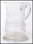 A 19th century Victorian glass handled tankard having etched floral decoration, monogrammed M. M. D.