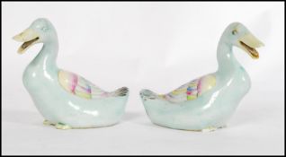 A pair of 19th century Chinese Ming style pottery ducks, each polychrome decorated predominantly