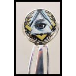 A stamped 925 silver book mark with an enamelled masonic image of an eye to the finial. Weight 5.