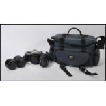 A vintage cased 35mm Minolta XG-M camera together with a Sigma UC 70-120mm Macro lens, Minolta MD