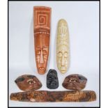 A selection of 20th century African tribal wall masks to include a pair of monkey face masks with