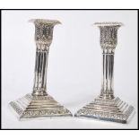 A pair of 19th Century William Hutton & Sons silver plated candlesticks, having graduating square