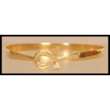 An 18ct gold Egyptian gold bangle bracelet having a Ankh hidden clasp. Egyptian hallmarks present to
