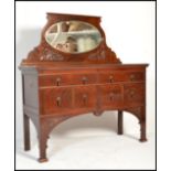 An Edwardian mahogany sideboard having squared legs with a series of drawers to the small