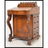 A Victorian walnut davenport, circa 1860, having remains of  fitted interior enclosed by writing