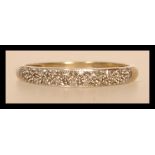 A hallmarked 9ct gold and diamond half eternity ring having half decoration with illusion set