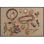 A selection of white metal and silver jewellery to include a souvenir bracelet with enamelled