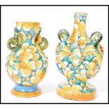 A near pair of vintage 20th century decorative Faience vases raised on circular bases with hoop