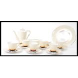 A vintage 20th century Art Deco tea / coffee service consisting of tall teapot, six cups and