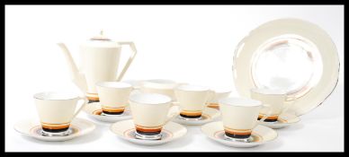 A vintage 20th century Art Deco tea / coffee service consisting of tall teapot, six cups and