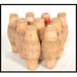 A set of nine vintage early 20th century wooden pub bowling pins / skittles, remnants of original