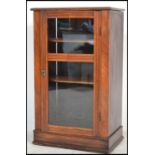 A 19th Century mahogany glazed cabinet on a plinth base with a panelled glass and reeded detailing