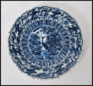A 19th Century Delft display / serving plate of round form, having hand painted blue and white