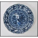 A 19th Century Delft display / serving plate of round form, having hand painted blue and white