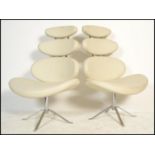 A pair of 20th century modernist designer chrome and leather effect pebble swivel chairs / armchairs
