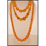 A group of three vintage butterscotch amber bakelite bead necklaces, longest measures approx 30