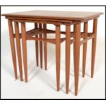 A nest of three Danish retro teak wood side tables, the graduating three tables raised on shaped