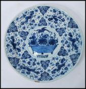 A 19th Century Delft display / serving plate of round form, having hand painted blue and white