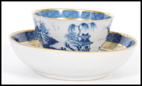 An early 19th century Chinese blue and white tea bowl with matching saucer the central cartouche