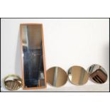 A collection of five retro 20th Century wall mirrors to include three matching circular wall