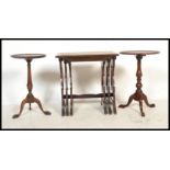 A pair of Georgian revival mahogany tripod wine tables with circular tops and splayed leg bases