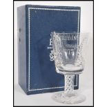 A cased Stuart Crystal QE2 Silver Wedding cut glass large goblet raised on circular foot with air