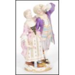 A 19th century Meissen porcelain figurine group of a gallant and companion raised on scrolled
