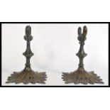 A pair of 19th century bronze scroll holders raise