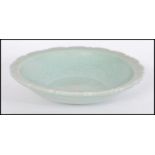 A Chinese celadon glaze bowl of scalloped form having floral motifs and decoration. Measures 5cm-