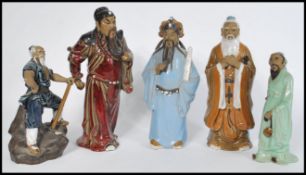 A group of five 20th century Oriental Chinese and Japanese pottery and ceramic figurines of