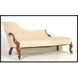 A 19th century Victorian rosewood chaise longue - sofa day bed. The show wood scrolled frame with