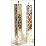 A pair of vintage 20th century mirrored column lamps of square form having graduating circles with