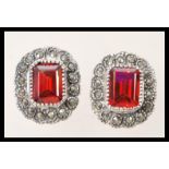 A pair of silver Renaissance style earrings with central faceted square rubilite's with marcasite