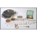 A collection of silver plated items to include a toast rack and tray, various ladles and serving