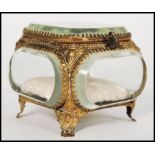 A 19th century French bronze casket trinket box having multiple bevelled glass panels raised on