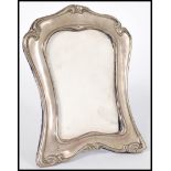 An early 20th century silver hallmarked picture frame having a purple velour easel back. The frame