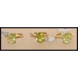Three 925 silver vermeil ladies rings set with a large oval cut green stones in prong settings. A