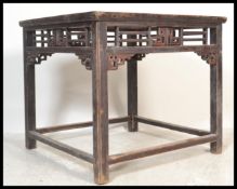 A 19th Century Qing Dynasty period Chinese square hardwood centre table, the fretted and carved