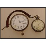 A large vintage 20th century Goliath pocket watch car clock along with another pocket watch on