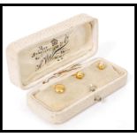 A set of two 18ct gold collar stud buttons complete in fitted case along with a rolled gold