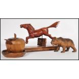 A collection of treen items to include a Black Forest bear, a horse jumping a fence and a lidded