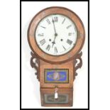 A 20th century inlaid drop dial wall clock, oak cased with a round face having roman numerals to the