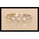 A hallmarked 18ct gold ring set with three brilliant cut diamonds total approx 35 pts. Size N.5.