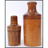 Two early 20th Century turned olive wood bottle casings with screw lids concealing bottles to the