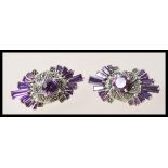 A pair of silver dress earrings set with amethysts and marcasite accent stones. Weight 12.7g.