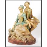 A large oversized 1920's chalkware figural group statue of a Georgian lady and gentleman sitting