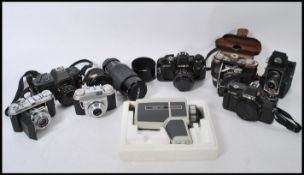 A collection of vintage cameras, lenses and accessories to include a Ross Ensign, Retina, Pentax,