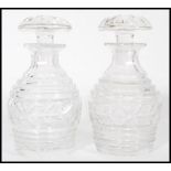 A pair of vintage 20th century cut glass crystal decanters of bulbous form complete with flat top