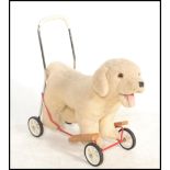 A vintage retro Mulholland & Bailie puppy push toy, the Labrador style puppy raised on a tubular